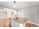 Granite kitchen island featuring stainless steel sink with seating, bright lighting, and appliances at 5100 Clay St, Denver, CO 80221