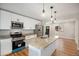 Updated kitchen with granite countertops, stainless steel appliances, and modern island at 5100 Clay St, Denver, CO 80221