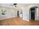 Sunny living room features sleek ceiling fan and hardwood floors, flowing to other rooms at 5100 Clay St, Denver, CO 80221