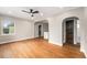 Bright living room showcases hardwood floors, neutral walls, and arched doorways to other rooms at 5100 Clay St, Denver, CO 80221