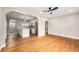 Bright, open living room with beautiful hardwood floors and arched entry to the kitchen at 5100 Clay St, Denver, CO 80221