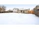 Snow-covered backyard showcasing the home's exterior and spacious outdoor area, perfect for winter activities and relaxation at 5153 Tucson Way, Denver, CO 80239