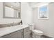 Bright bathroom showcasing modern fixtures, a gray vanity, and a window for natural light, creating a fresh, clean aesthetic at 5153 Tucson Way, Denver, CO 80239