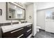 Bright bathroom features double sinks, a large mirror and sleek dark tile flooring at 5153 Tucson Way, Denver, CO 80239