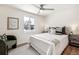 Cozy bedroom with a ceiling fan, plush bedding, and a large window for ample natural light at 5153 Tucson Way, Denver, CO 80239