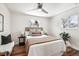 Bright bedroom with neutral decor, stylish bedding, and a sunny window at 5153 Tucson Way, Denver, CO 80239