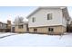 Well-maintained home with a combination of brick and siding, offering a classic suburban appeal with snowy yard at 5153 Tucson Way, Denver, CO 80239