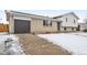 Exterior showcasing brick facade, an attached garage, and a driveway in a residential neighborhood at 5153 Tucson Way, Denver, CO 80239