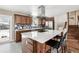 Stylish kitchen with island seating, stainless steel appliances, and backsplash, ideal for cooking and entertaining at 5153 Tucson Way, Denver, CO 80239