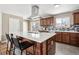 Contemporary kitchen featuring a large island with barstools, stainless appliances, and ample countertop space at 5153 Tucson Way, Denver, CO 80239