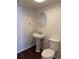 Bathroom featuring hardwood floors, a vanity sink and a toilet at 13959 Eudora St, Thornton, CO 80602