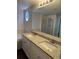 Bathroom with a double vanity, granite countertops, shower, and soaking tub at 13959 Eudora St, Thornton, CO 80602