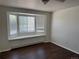 Charming bedroom with bay window, built-in seating, and updated flooring at 13959 Eudora St, Thornton, CO 80602