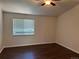 Bedroom with updated floors and natural light from large window with blinds at 13959 Eudora St, Thornton, CO 80602