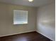 Simple bedroom featuring modern floors and a bright window at 13959 Eudora St, Thornton, CO 80602