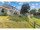 View of sloping backyard and fence of attached townhomes on a bright day at 8260 Washington St # 78, Denver, CO 80229