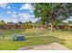 Spacious grassy backyard featuring a mix of tall trees and sturdy wood fencing at 8260 Washington St # 78, Denver, CO 80229