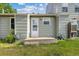 Back of building with concrete pad and outdoor faucet; small grass area at 8260 Washington St # 78, Denver, CO 80229