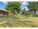 Expansive, well-maintained backyard framed by rustic fencing and mature, shady trees at 8260 Washington St # 78, Denver, CO 80229