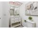 Well-lit bathroom features a modern white vanity, decorative ceiling light, and stylish tiling in the shower at 8260 Washington St # 78, Denver, CO 80229