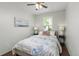 Cozy bedroom with hardwood floors, a comfortable queen bed, and bright window view at 8260 Washington St # 78, Denver, CO 80229