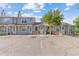 Charming townhouse complex with designated parking spots, well-maintained facades, and mature trees at 8260 Washington St # 78, Denver, CO 80229
