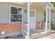 Close up of the front porch with white railings and brick foundation at 8260 Washington St # 78, Denver, CO 80229