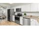Modern kitchen featuring stainless steel appliances, granite counters and white cabinetry at 8260 Washington St # 78, Denver, CO 80229