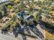 Aerial view showcases the house with well-kept landscaping, a pool, and two outbuildings at 9630 N Surrey Dr, Castle Rock, CO 80108
