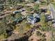 Overhead view of a home with a pool and solar panels, situated amid lush trees at 9630 N Surrey Dr, Castle Rock, CO 80108