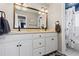 Well-lit bathroom with double vanity, large mirror and a view of the toilet/shower area at 9630 N Surrey Dr, Castle Rock, CO 80108