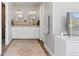 Bright bathroom features double sinks, carpet, and modern finishes at 9630 N Surrey Dr, Castle Rock, CO 80108
