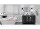 Modern bathroom featuring sleek vanity, freestanding tub, and stylish decor at 9630 N Surrey Dr, Castle Rock, CO 80108