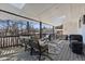 Relax on this covered deck with cozy seating, string lights, and tranquil views at 9630 N Surrey Dr, Castle Rock, CO 80108