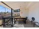 Enjoy outdoor dining on this charming covered patio with a wooden table and chairs at 9630 N Surrey Dr, Castle Rock, CO 80108