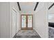 Inviting entryway with wooden doors, board and batten accents and a floral area rug at 9630 N Surrey Dr, Castle Rock, CO 80108