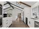 Spacious kitchen with white cabinets, hardwood floors, and stainless steel appliances at 9630 N Surrey Dr, Castle Rock, CO 80108