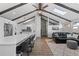 Open-concept living room features vaulted ceilings, exposed beams, and seamless flow into a modern kitchen at 9630 N Surrey Dr, Castle Rock, CO 80108
