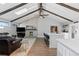 Bright open-concept living space with beamed ceilings, a fireplace, and modern flooring at 9630 N Surrey Dr, Castle Rock, CO 80108