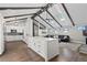 Open-concept space with a modern kitchen, hardwood floors, and wood beams, filled with natural light at 9630 N Surrey Dr, Castle Rock, CO 80108