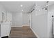 Bright main bedroom features wood floors, barn door closet, and updated walk-in shower at 9630 N Surrey Dr, Castle Rock, CO 80108