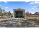 Open outbuilding with gravel floor, perfect for equipment storage or a workshop at 9630 N Surrey Dr, Castle Rock, CO 80108