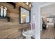 Stylish powder room with wood accent wall, modern fixtures, and elegant lighting at 9630 N Surrey Dr, Castle Rock, CO 80108