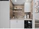 A charming wet bar area featuring stylish shelving, a sink, and a convenient wine cooler at 9630 N Surrey Dr, Castle Rock, CO 80108