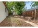 Backyard featuring garden beds, a tool shed and a wood fence at 1057 S Osceola St, Denver, CO 80219