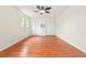 Spacious bedroom with beautiful wood floors, window, modern ceiling fan, and closet system at 1057 S Osceola St, Denver, CO 80219