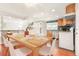 Dining room showcasing table and chairs and an open kitchen with modern appliances at 1057 S Osceola St, Denver, CO 80219