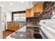 Close up of a kitchen with oak cabinets, tile backsplash, modern appliances, and natural lighting at 1057 S Osceola St, Denver, CO 80219