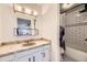 Bathroom featuring white subway tile in shower/tub and patterned tile floor at 4934 S Flower Way, Littleton, CO 80123