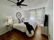 Bright bedroom with a cozy bed, white linens, and large window with sheer curtains at 4934 S Flower Way, Littleton, CO 80123